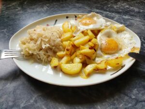 Antiaging with healthy food. Here roasted potatoes with fried eggs and sauerkraut-salad.
